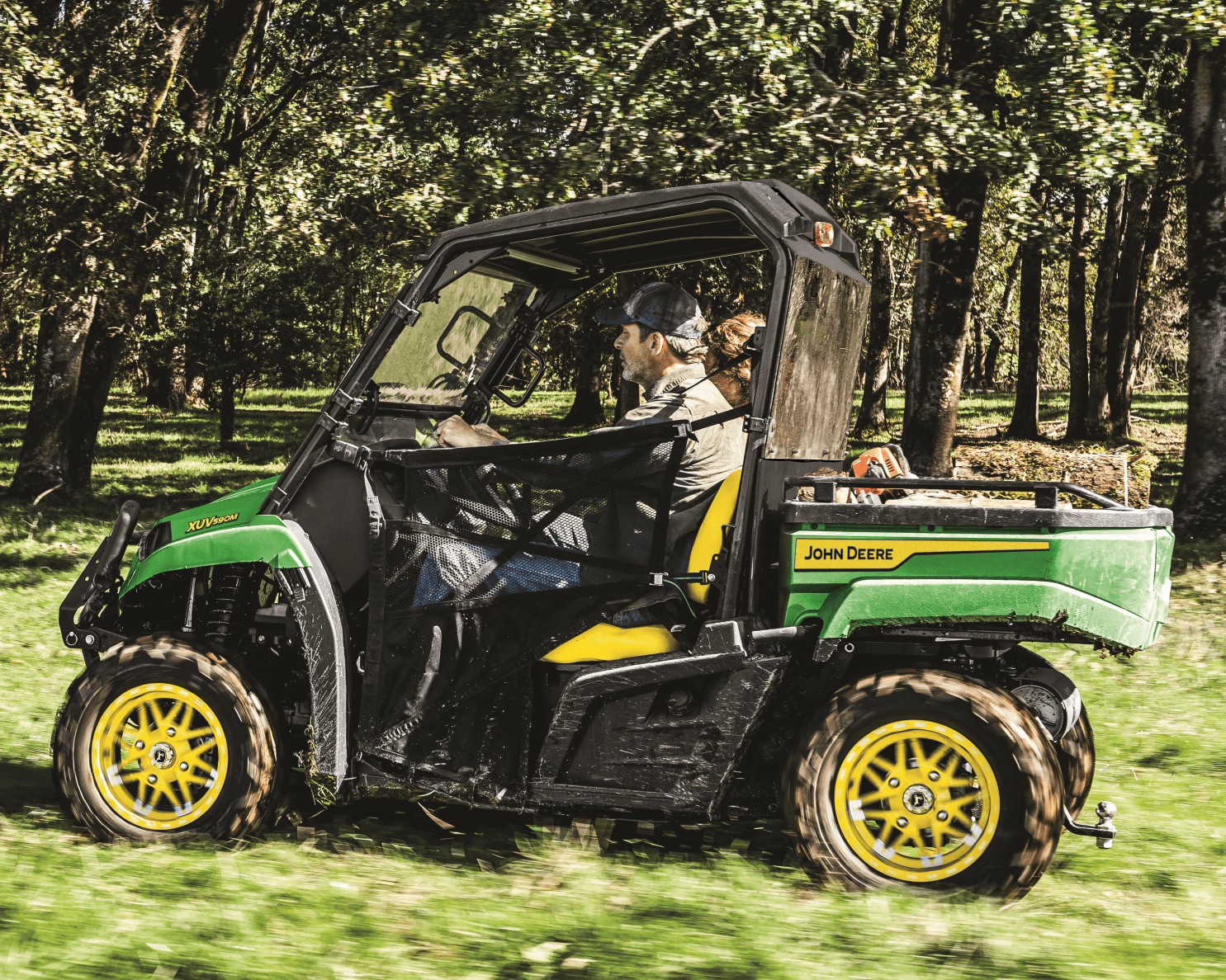 A farmer on a John Deere XUV590M surveys his urban farm in California.