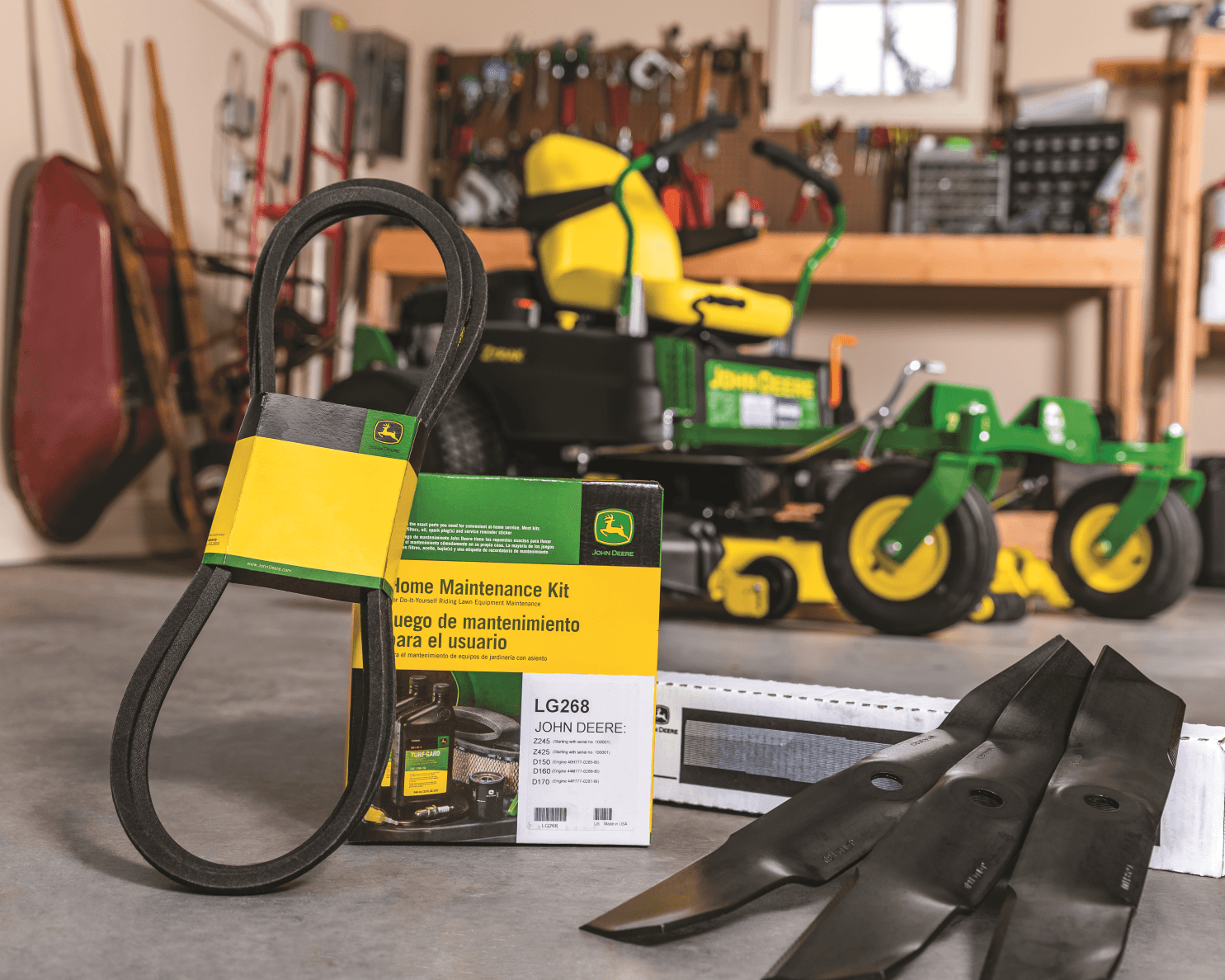 Various lawnmower replacement items like belts and mower blades are shown in front of a zero-turn mower.