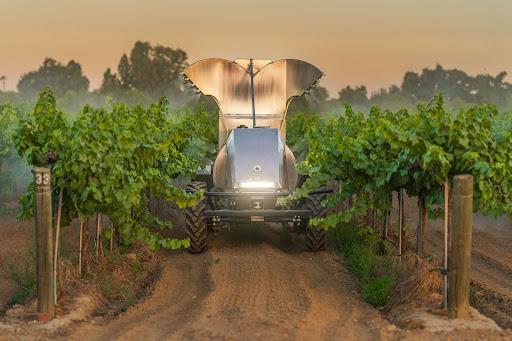 A GUSS automated sprayer sprays an orchard in California.