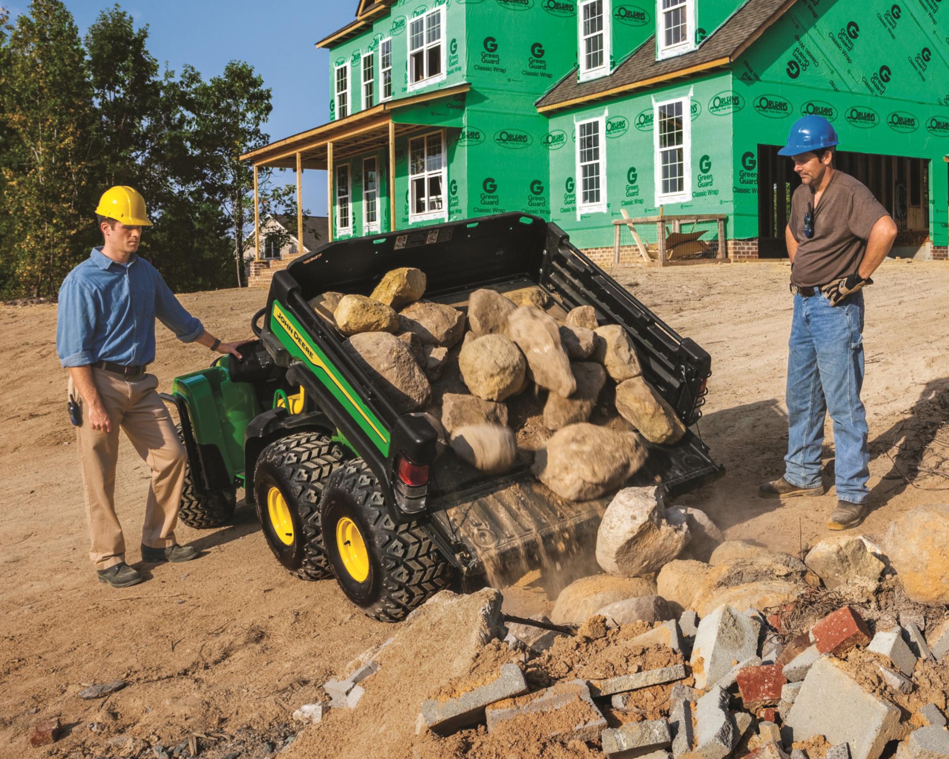 John Deere Gator TH 6x4 dumping rocks.