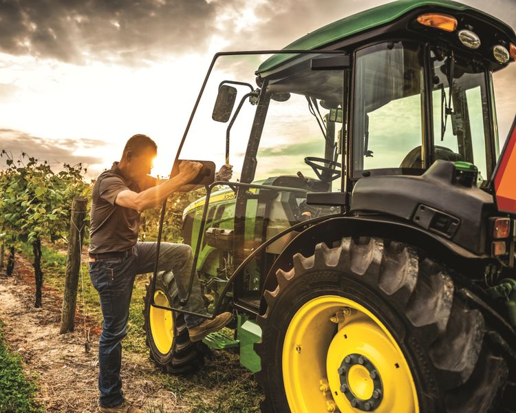 John Deere 5075N tractor in an orchard.