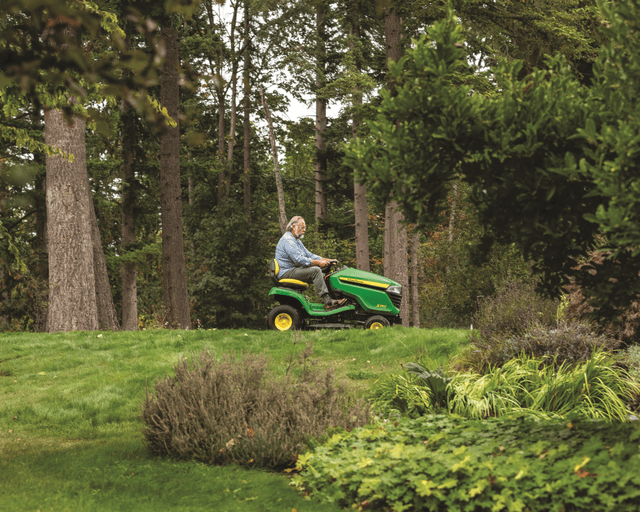 John Deere X350 A workers uses a John Deere Z350 lawn tractor on a lawn in California.